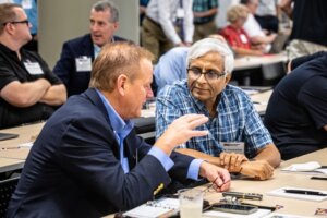 Tim Olson (left), founder and CEO of DECA in Tempe, chats with Vish Viswanathan of NXP Semiconductors during a break at the Southwest Advanced Prototyping Hub workshop for microelectronics. (Photo by Charlie Leight/ASU News)